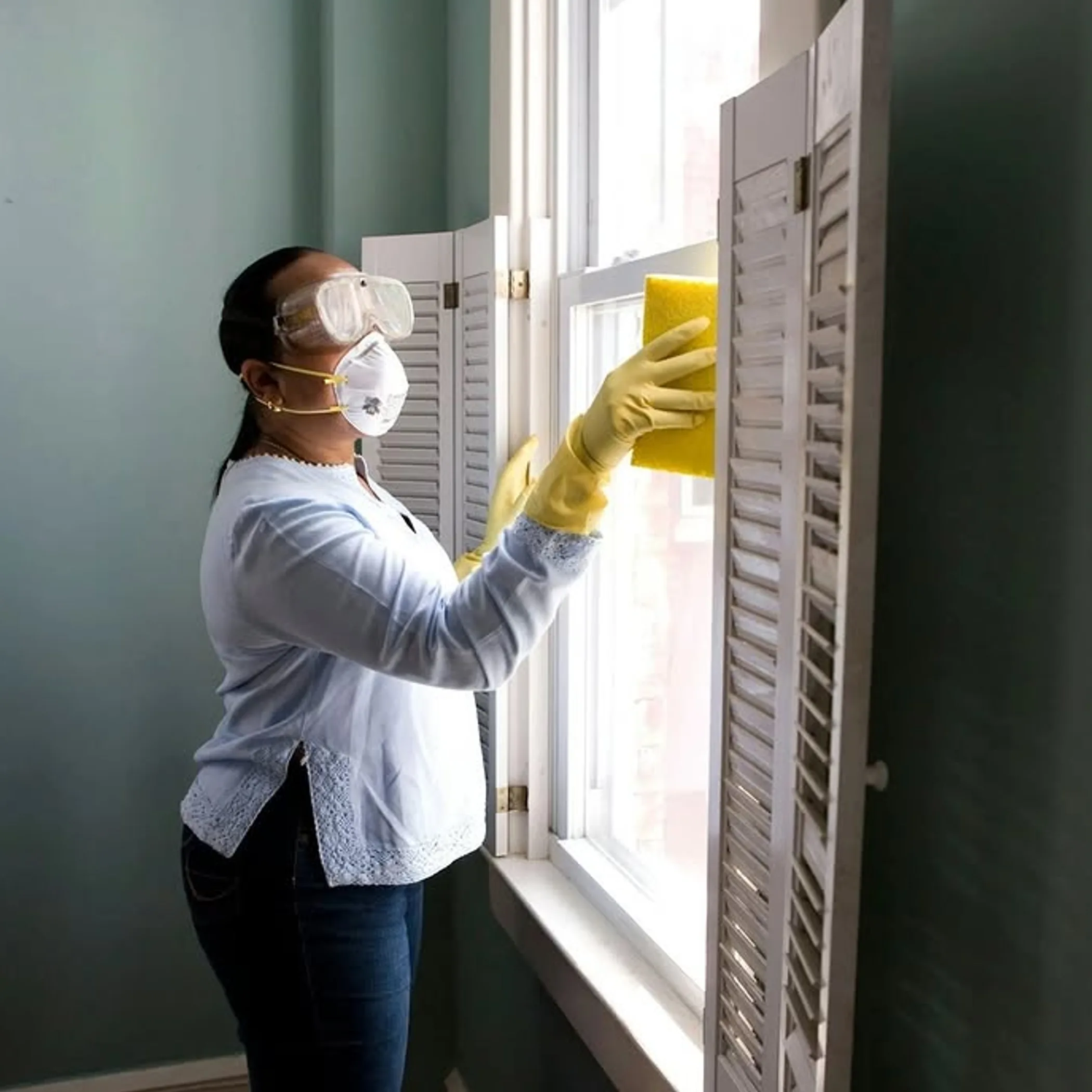 person cleaning a window